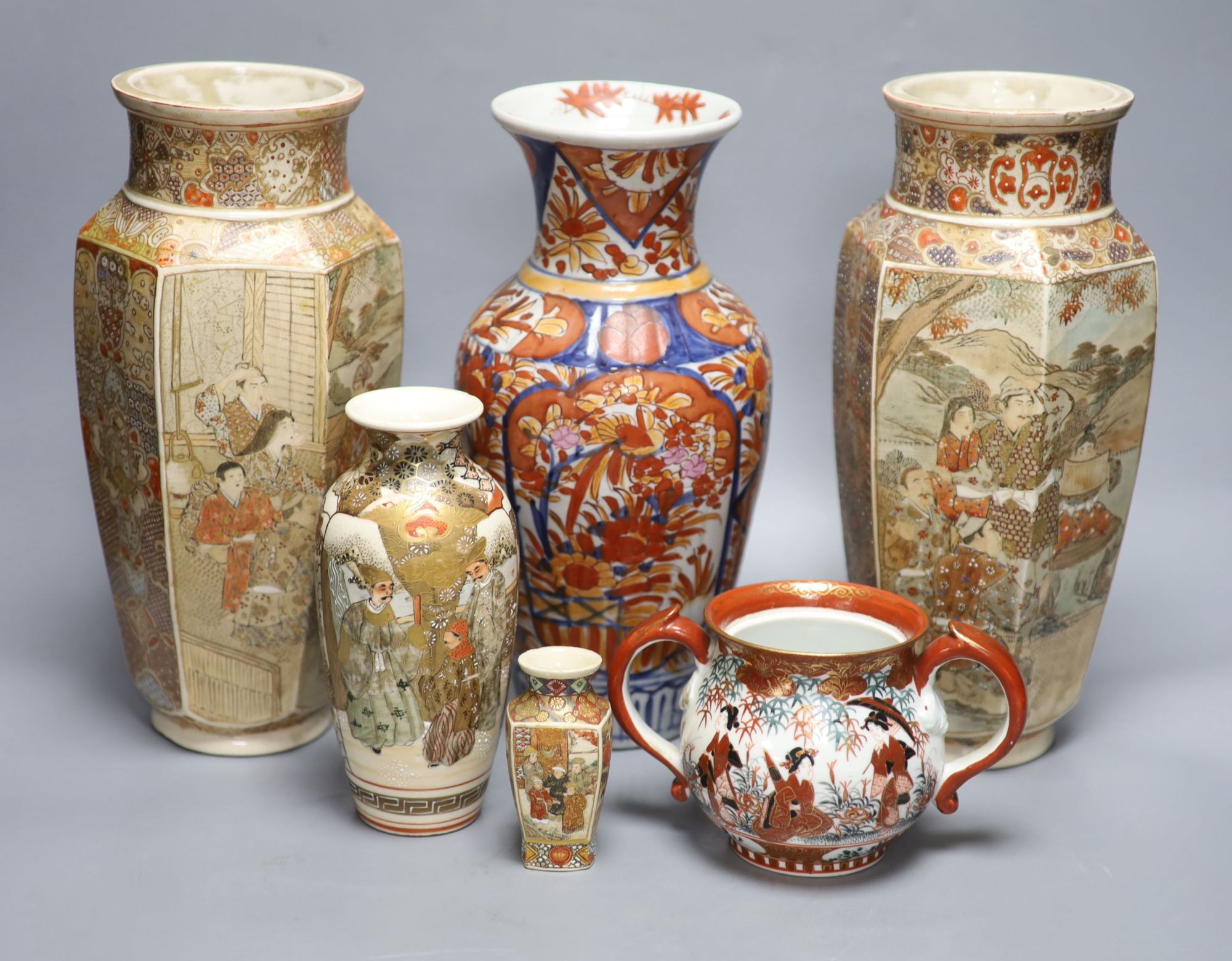 A pair of Japanese Satsuma vases, two others, an Imari vase and a two handled pot, tallest 31cm,